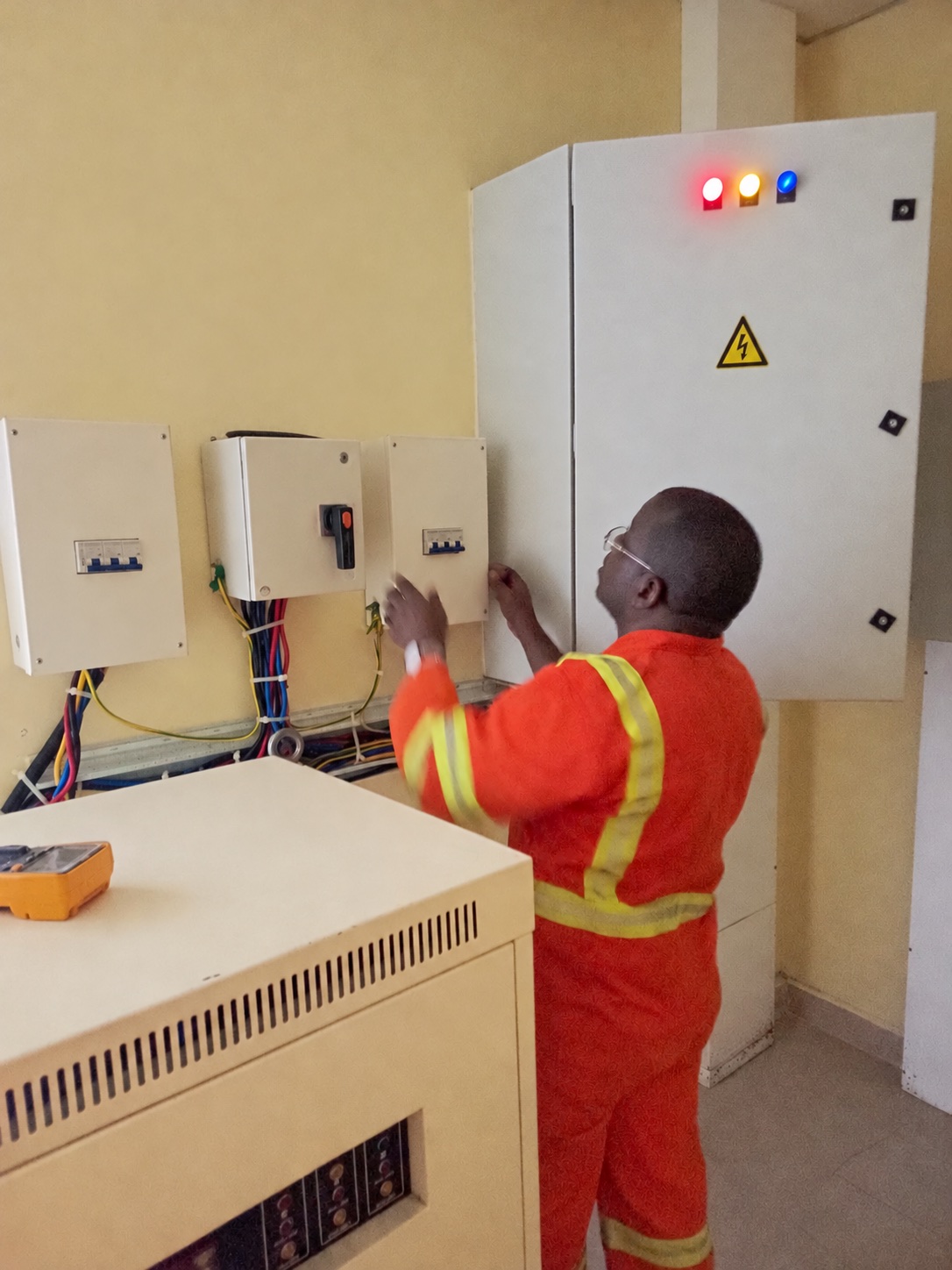 Field engineer inspecting unbranded electrical distribution equipment