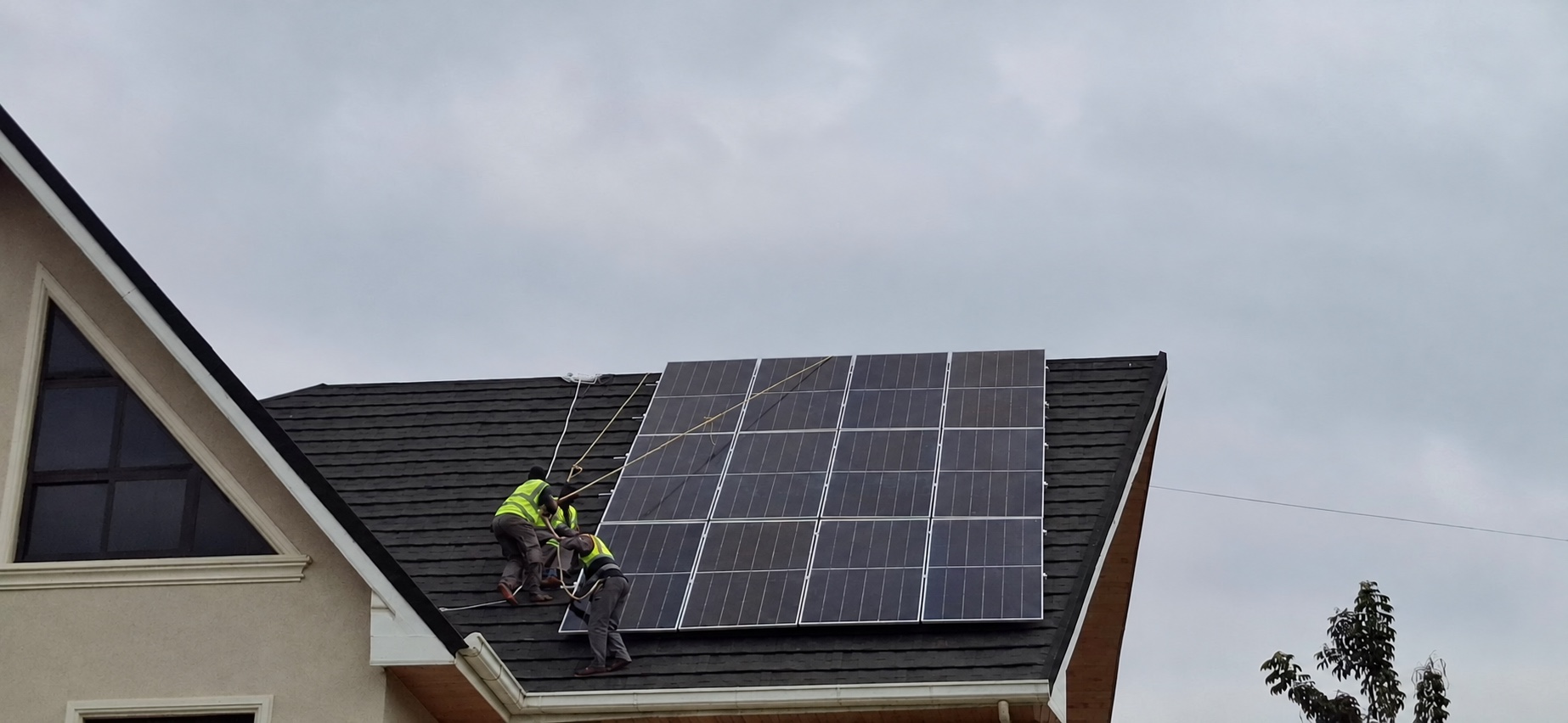 Technicians installing a large rooftop solar array
