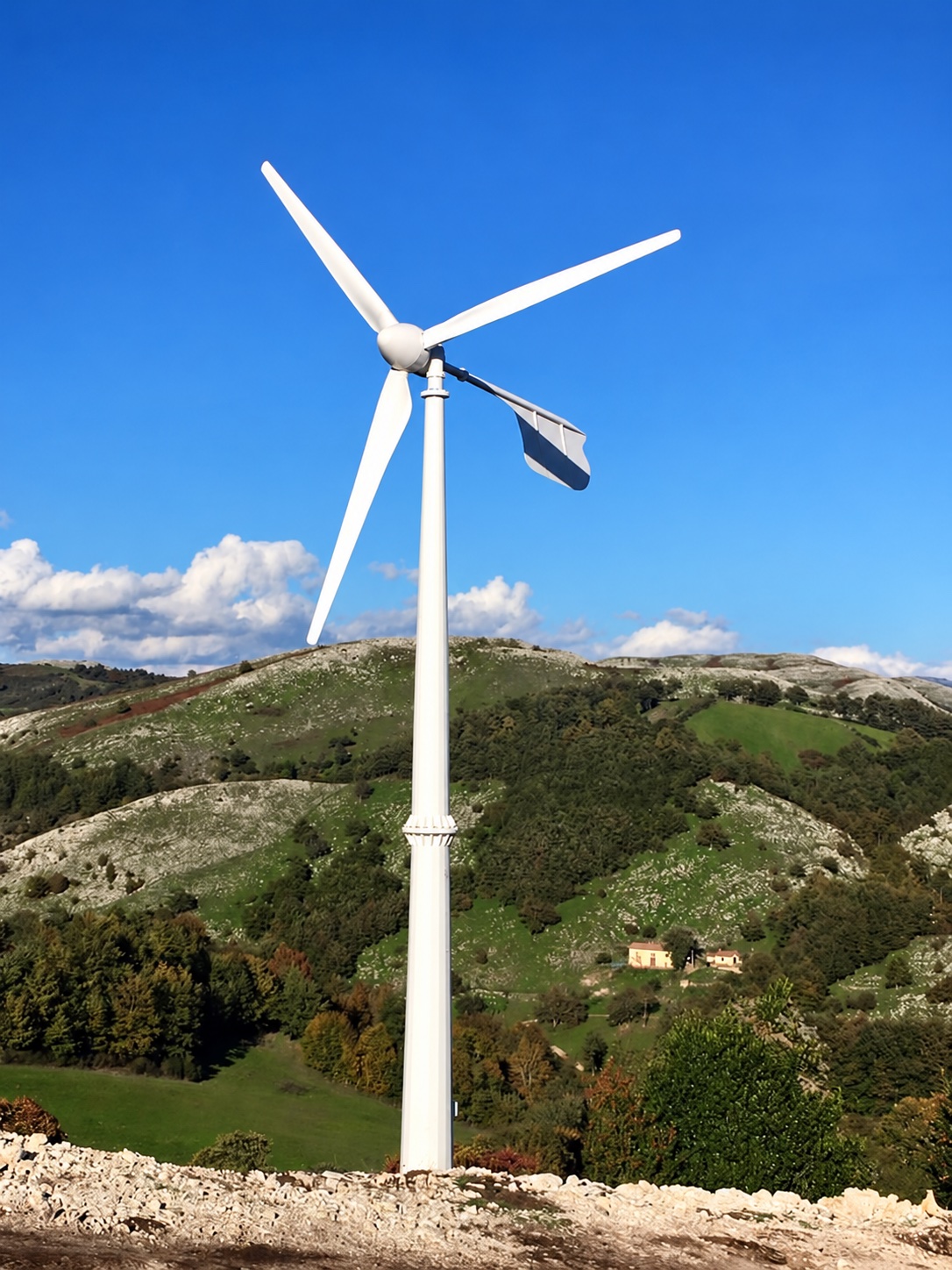 Horizontal-axis turbine installation from the supplier UHWT 20 kW listing, showing three blades, rear tail vane and monopole