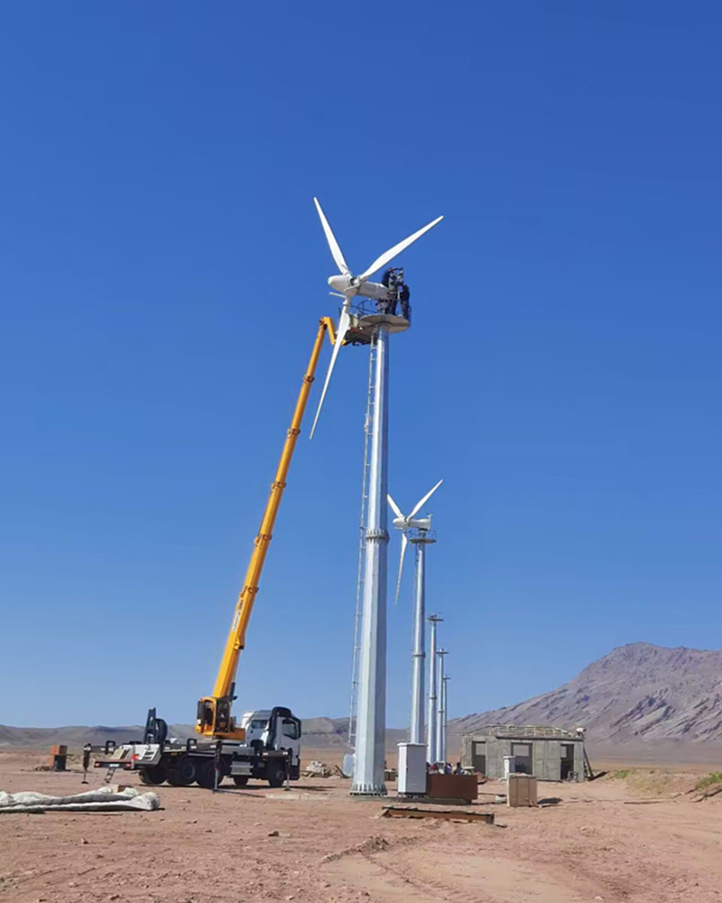 Anhua AH-30KW supplier installation photograph showing horizontal-axis turbines and a maintenance lift