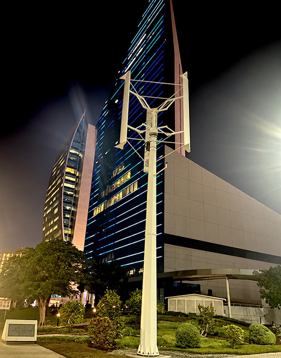 Aeolos-V 5 kW manufacturer installation photograph showing a large straight-blade vertical turbine at night