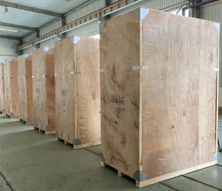 A row of plywood equipment cases staged inside a supplier warehouse
