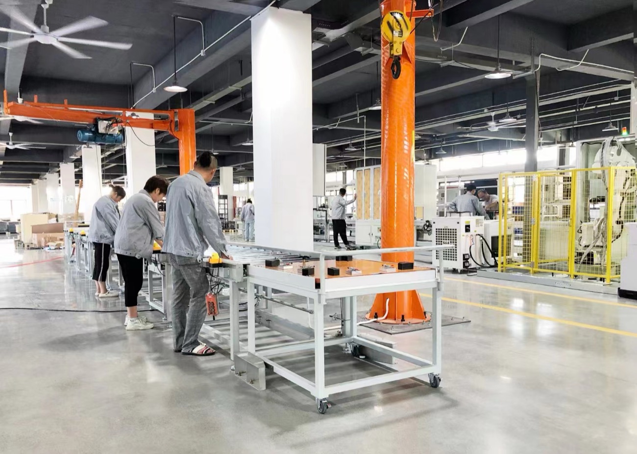 Equipment assembly floor with workers and production machinery
